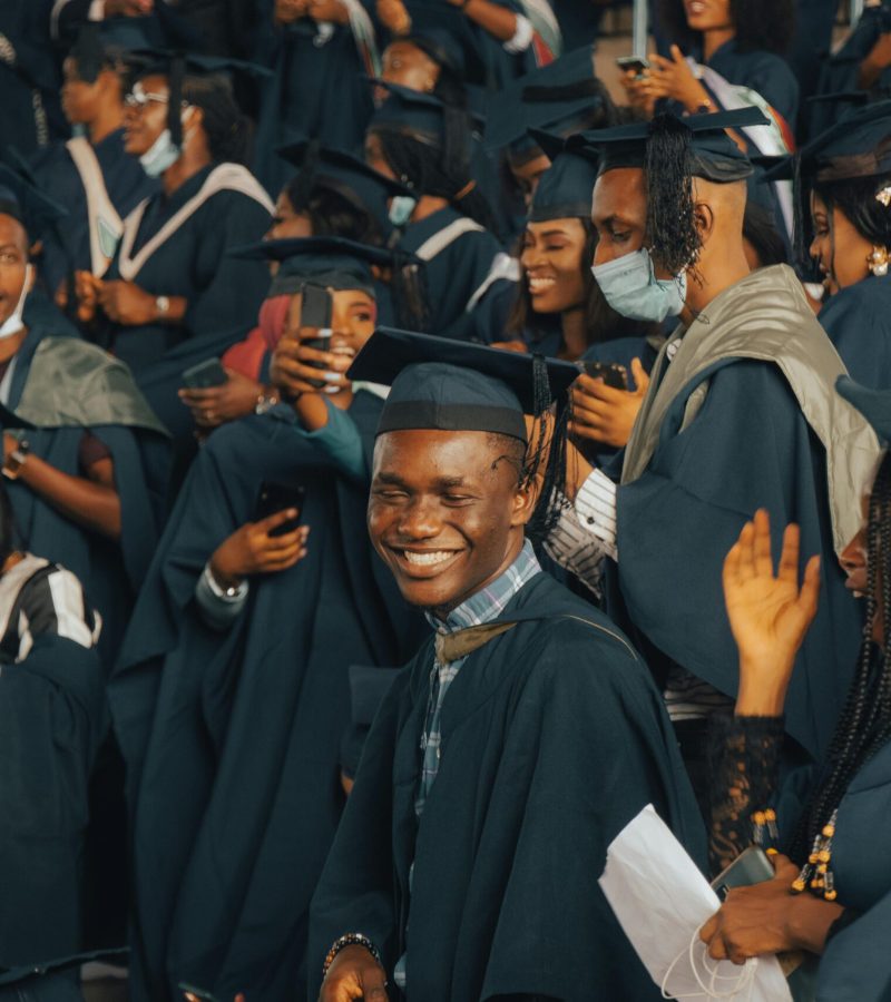 A group of happy graduates celebrating their achievements at a Nigerian university graduation ceremony.