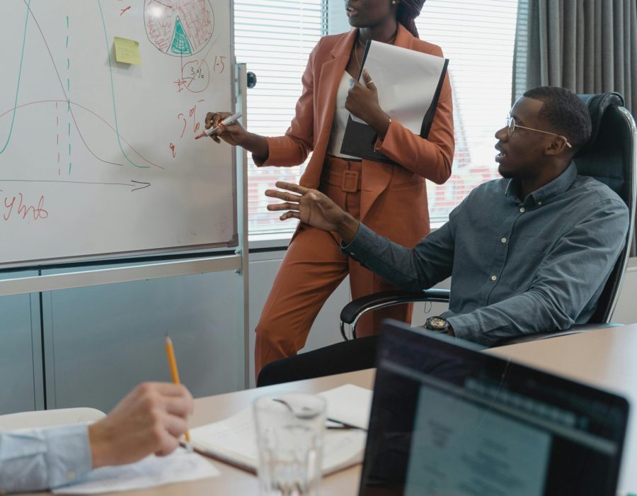 A diverse team discusses strategies during a meeting in a modern office setting.
